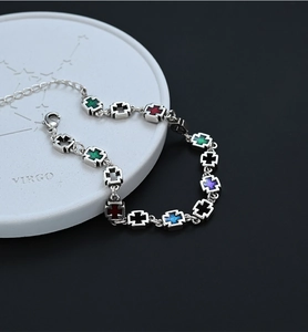 Detail of colorful enamel cross pendants with adjustable lobster clasp chain link