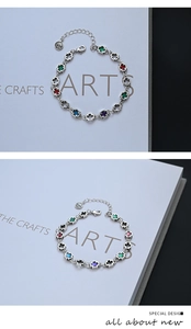 Detail of S925 sterling silver stamp and colorful enamel cross charms on the bracelet