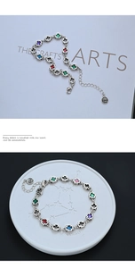 Detailed macro view of S925 sterling silver bracelet with colorful enamel crosses