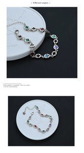 Detailed macro view of S925 silver bracelet featuring colorful enamel cross charms