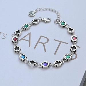 Handcrafted S925 sterling silver cross bracelet with colorful enamel inlay on white background