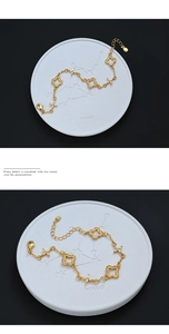 Macro detail of a gold flower bracelet with sparkling cubic zirconia and lobster clasp