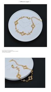 Detail of gold clover and starburst bracelet with white zircons and S925 engraved tag