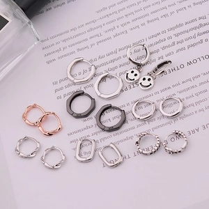 Close-up of S925 sterling silver hoop earrings with diverse textures and hallmark
