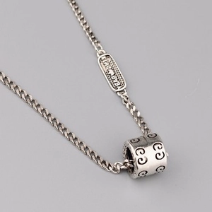 Macro shot of S925 sterling silver ball chain necklace with vintage textured pendant