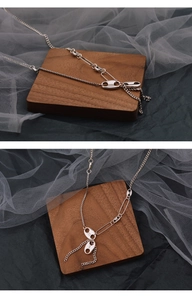 Detailed view of the multi-chain silver necklace featuring pig nose links and paperclip rings