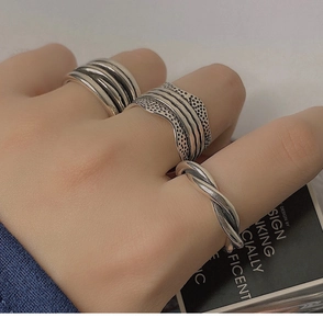 Detail of vintage silver multi-layer stackable rings with textured engraving on fingers