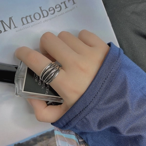 Vintage multilayer silver-tone ring with layered twist design for women on a model hand
