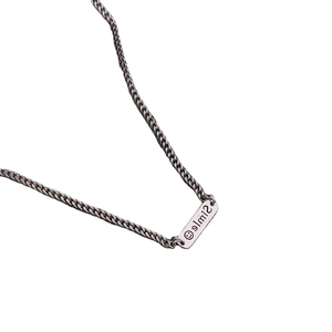 Retro Thai silver necklace with a rectangular Smile pendant on a long sweater chain