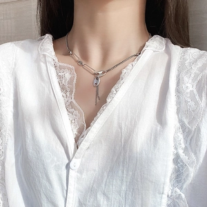 Minimalist silver fringe necklace with asymmetrical bead chain and coffee bean pendant
