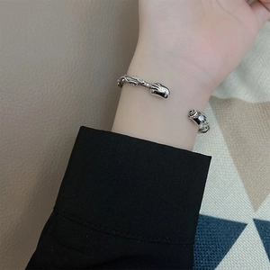 Vintage Thai silver rose cuff bracelet with intricate floral carvings on wrist