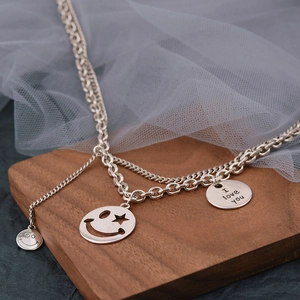 Double-layered chain necklace with smiley face charms and I Love You engraved tag