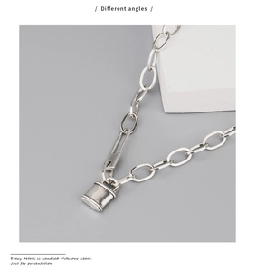 Détail du collier pendentif cadenas argent vintage avec chaîne à maillons ovales sur socle