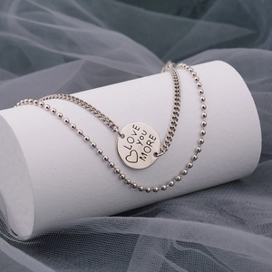 Double-layered silver necklace with circular Love You More engraved pendant for women