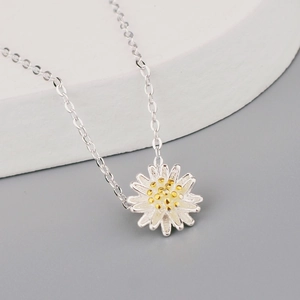 Chic silver daisy pendant necklace with white enamel petals and gold center detail