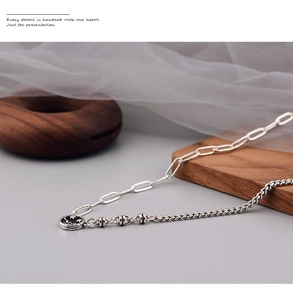 Close-up of retro silver hollow smiley pendant with asymmetrical拼接 industrial chain