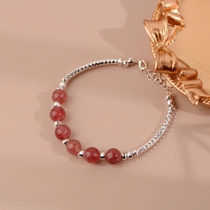 Detailed view of the strawberry crystal beaded bracelet with lobster clasp and extension chain