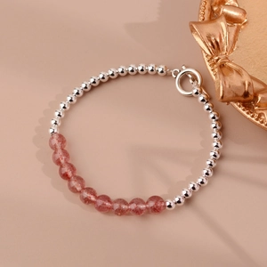 Detail of beads with red strawberry quartz and silver metallic beads on the bracelet