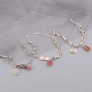 Close-up of S925 sterling silver stamp on a strawberry quartz charm bracelet set