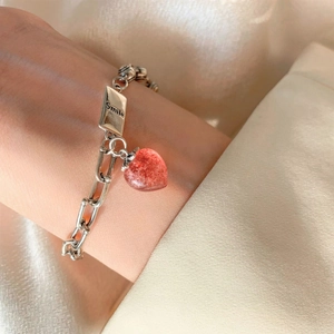 Vintage silver chain bracelet featuring a red strawberry quartz heart and Smile engraving