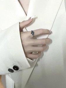 Close-up of gothic bat ring with black gemstone on silver finish finger jewelry