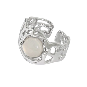 Macro detail of silver adjustable open ring with moonstone and hollow organic design