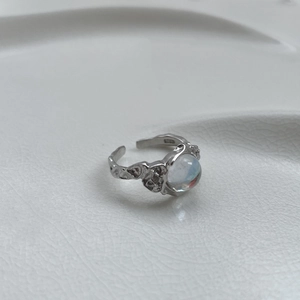 Macro shot of S925 sterling silver ring with hammered texture and moonstone