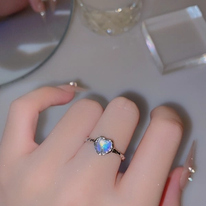 Close-up of heart-shaped moonstone ring with irregular silver lava texture