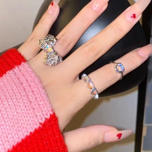 Three-piece set of moonlight stone heart rings with bow design on a female hand