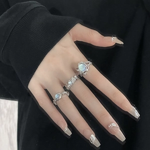 Three-piece silver lava style ring set with moonstone gems on a model's hand