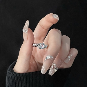Detail shot of a liquid lava silver ring with a blue moonstone on a hand