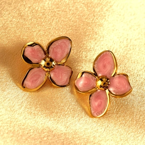 Pink enamel four-leaf flower stud earrings with gold plating on textured fabric