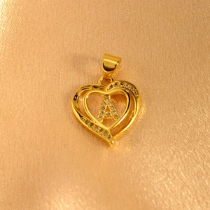 Detailed close-up of a heart-shaped gold-plated pendant featuring letter A with zircons