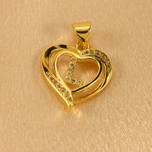Macro detail of gold-plated heart pendant with letter L and micro-pave white zircons
