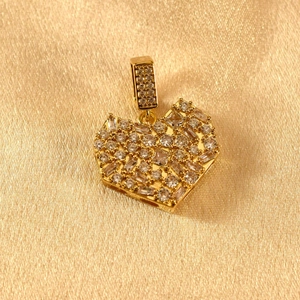 Close-up of gold-plated heart pendant with full pavé cubic zirconia on silk fabric
