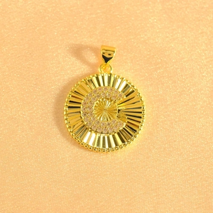 Macro shot of gold sunburst pendant featuring crystal pavé letter C with beaded edges