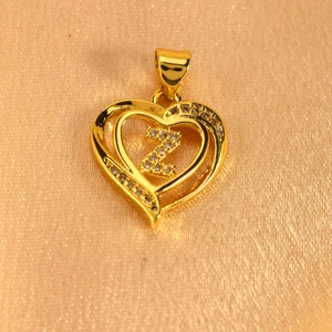 Detailed macro view of a gold heart pendant featuring a zircon-studded initial Z design