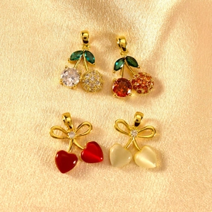 Sparkling cherry heart pendants with cubic zirconia and gold plating on silk