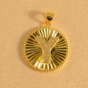 Close-up of gold-plated sunburst pendant featuring zircon-encrusted letter Y detail