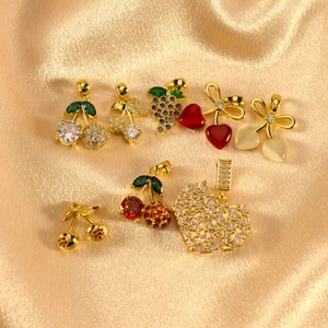 Sparkling crystal fruit and heart pendants featuring cherry and grape designs on satin