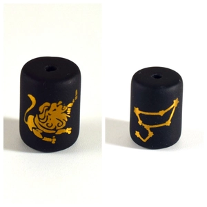 Detail view of matte black zodiac beads with golden Leo and constellation patterns