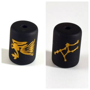 Detail of matte black beads featuring gold Virgo constellation and winged deity figures