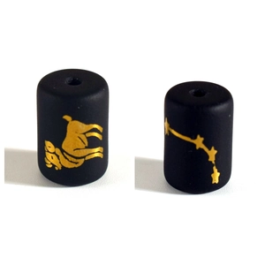 Detail of matte black glass beads with golden Aries zodiac sign and celestial star map patterns