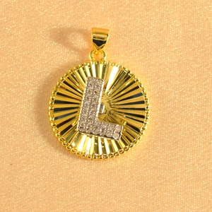 Detail of gold-plated sunburst pendant with crystal-set letter L and beaded edge