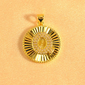 Macro detail of gold plated sunburst pendant with crystal inlaid letter Q on pearly fabric