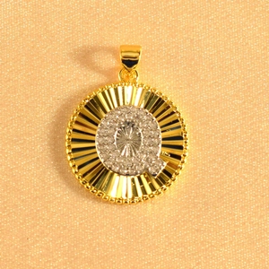 Macro shot of gold plated sunburst pendant featuring an iced-out letter Q in crystals