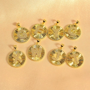 Golden sunburst round pendants with CZ inlaid letters G, F, Y, C, X, W, J, T on gold satin