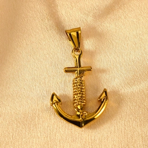 Detailed macro view of a polished golden anchor pendant with intricate rope wrapping detail