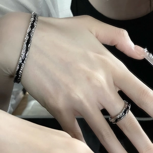 Irregular textured silver bangle and ring set with black enamel lava style finish
