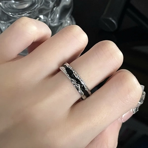 Irregular textured silver ring with black enamel inlay in a dark minimalist style